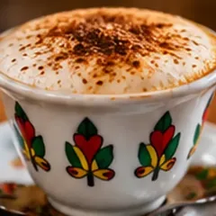 Cappuccino dusted with cocoa in a traditional Ethiopian cup