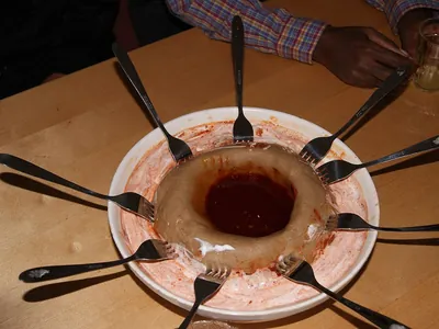 Genfo porridge with a well of spiced butter, ringed by spoons