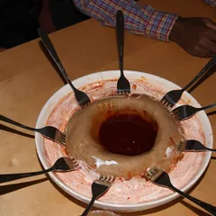 Genfo porridge with a well of spiced butter, ringed by spoons