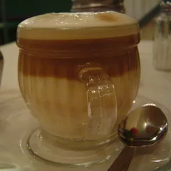 A layered macchiato in a glass cup, as served in Addis Ababa