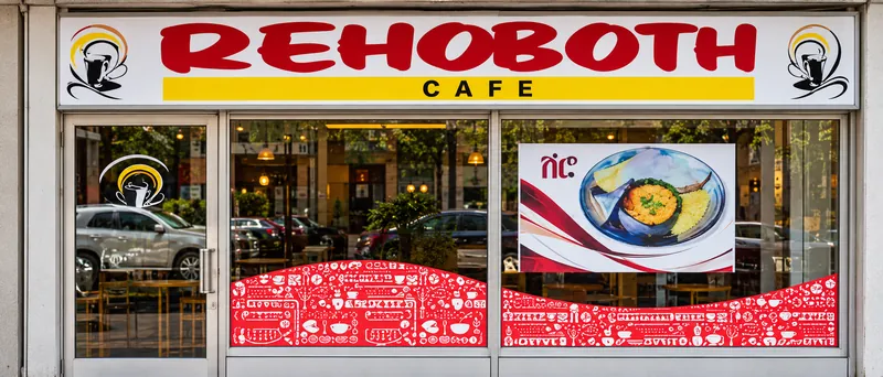 Rehoboth Cafe storefront on Danforth Avenue with its red and yellow sign