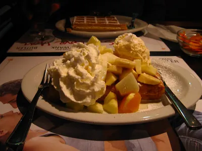 Waffle topped with fresh fruit and cream
