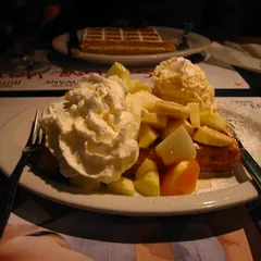 Waffle topped with fresh fruit and cream